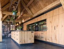 Rustieke keuken van hout in combinatie met de HPL Specials – Forest Green, welke de beleving geeft van het woud, boomschors en mos.