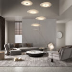 Renderafbeelding van een woonkamer met een wandafwerking in het solid surface marmerdecor Sun Kissed van Durasein